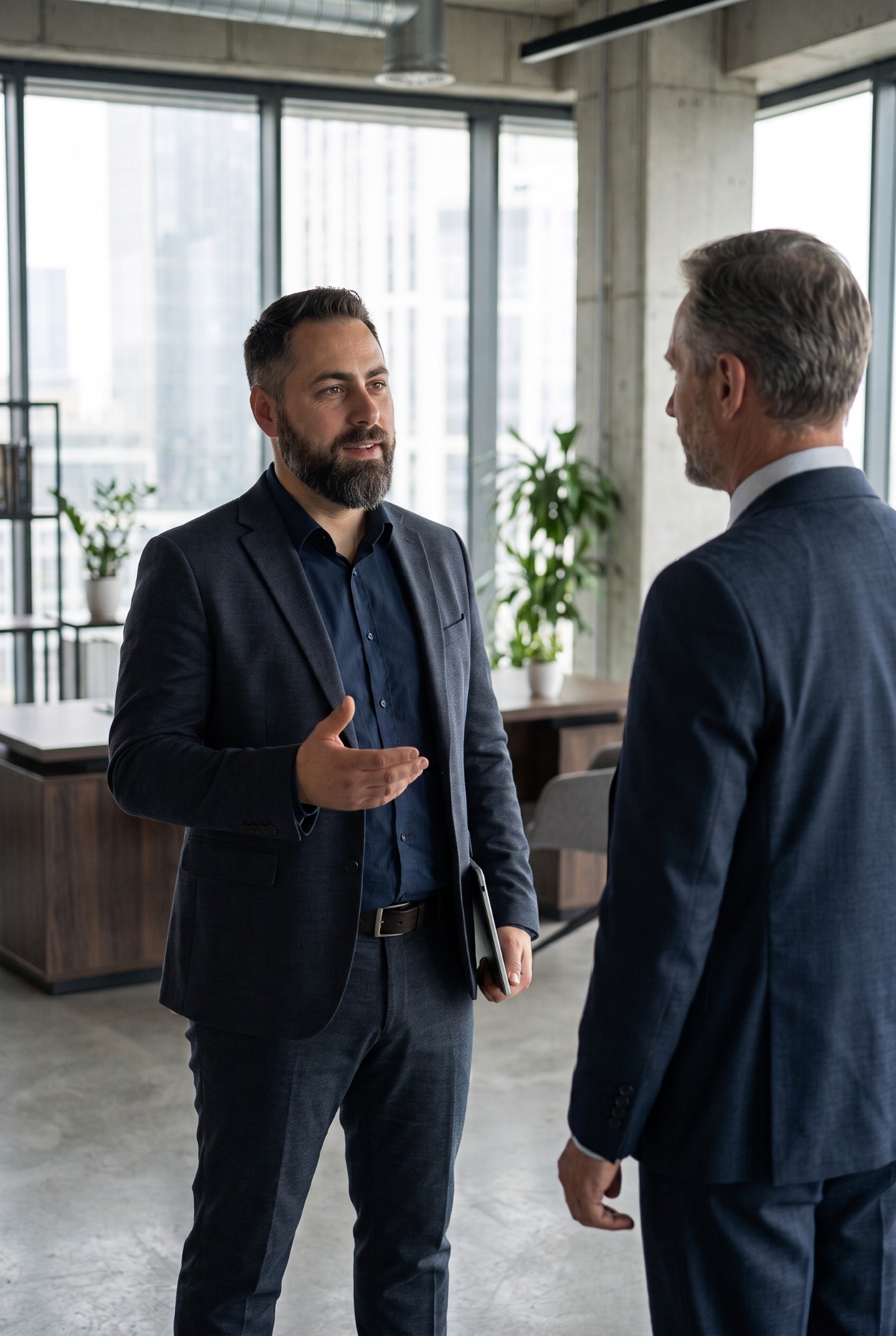 Bartek Filipek in conversation with a CEO in an office